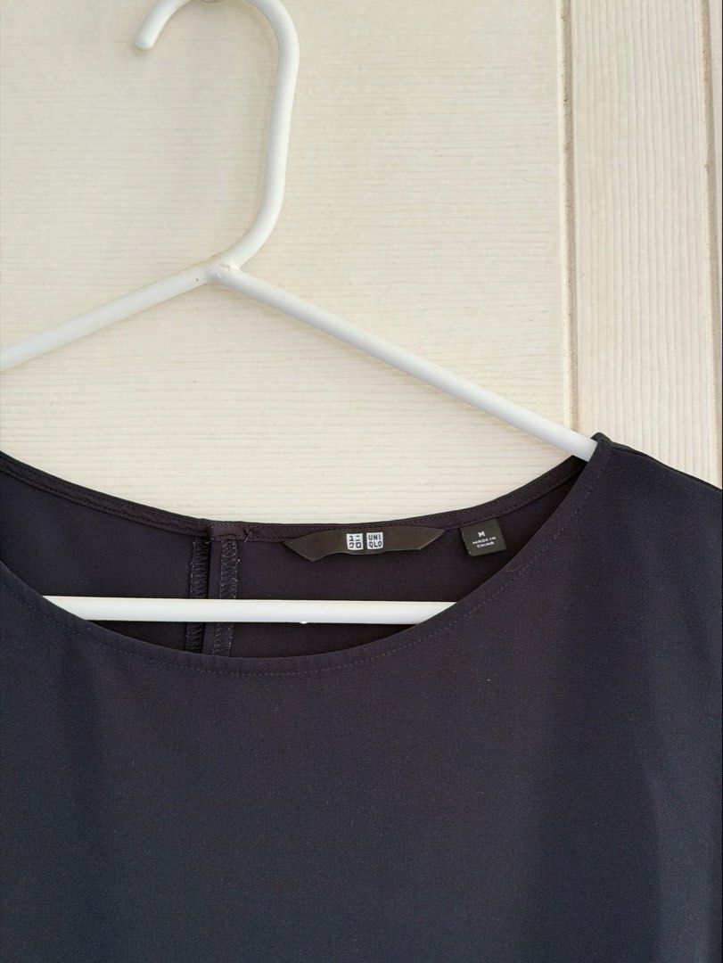 Uniqlo Navy Blue Top (Category: Sleeveless) located in Manila. Submitted by cinnmoroll (Listing ID 1469402411, Image 2). Description: - Brand: Uniqlo - Size: Medium - Color: Navy blue (solid dark blue) - Style: Sleeveless top with a scoop neckline - Material: Smooth, comfortable fabric - Condition: Excellent, with clean neckline label and tag intact - Versatility: Easy to pair with pants or skirts.