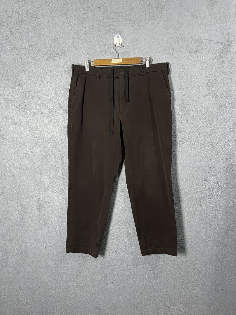 Uniqlo Smart Ankle EzyBrown Drawstring Trousers XL (Category: Trousers) located in Famy. Submitted by basicthrifted (Listing ID 1469405126, Image 1). Description: - Brand: Uniqlo - Color: Brown - Size: XL (fits waist 92-100cm) - Material: 93% cotton, 7% polyurethane (comfortable with good stretch) - Fit: Straight leg - Features: Built-in drawstring waist, front button closure - Condition: Clean overall, minimal signs of wear.