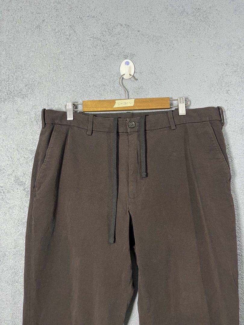 Uniqlo Smart Ankle EzyBrown Drawstring Trousers XL (Category: Trousers) located in Famy. Submitted by basicthrifted (Listing ID 1469405126, Image 2). Description: - Brand: Uniqlo - Color: Brown - Size: XL (fits waist 92-100cm) - Material: 93% cotton, 7% polyurethane (comfortable with good stretch) - Fit: Straight leg - Features: Built-in drawstring waist, front button closure - Condition: Clean overall, minimal signs of wear.