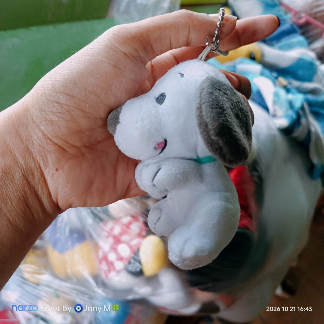 Universal Studios Japan Snoopy Plush Keychain (Category: Plushies & Soft Toys) located in Taguig. Submitted by mhayestufftoys (Listing ID 1469469857, Image 2). Description: - Authentic Universal Studios Japan (USJ) Snoopy plush keychain - Super soft white fur with cute grey floppy ears and detailed stitching - Comes with an attached metal ball chain for easy hanging - Official branding tag intact - Clean, fluffy, and in brand new-like condition.