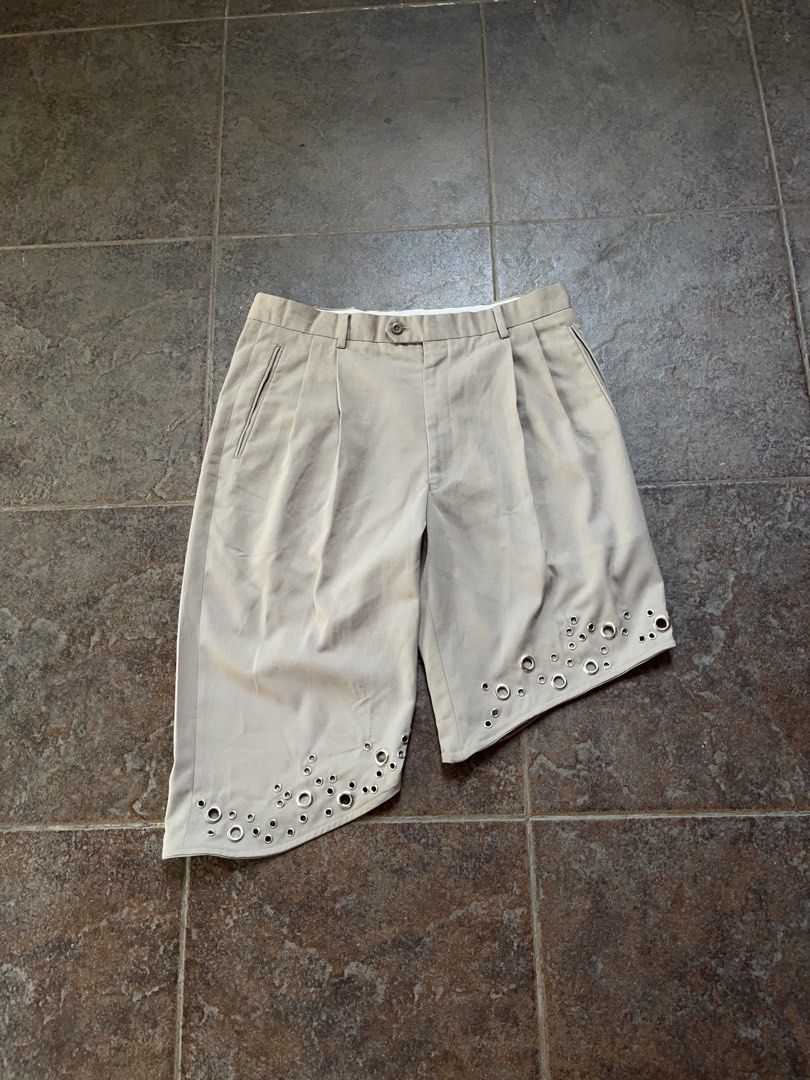 Upcycled Beige Asymmetrical Grommet Shorts (Category: Chinos) located in Lipa City. Submitted by m4rcuuu (Listing ID 1469431434, Image 2). Description: ONE OF ONE Upcycled Beige Asymmetrical Grommet Baggy Chino Shorts brand is Braggi by Louis Raphael in amazing condition upcycled shorts from dress pants, very baggy and roomy with asymmetrical hem and grommets,,, perfect with boots Measurements Waist: 34in Length of Left Leg: 20in Length of Right 