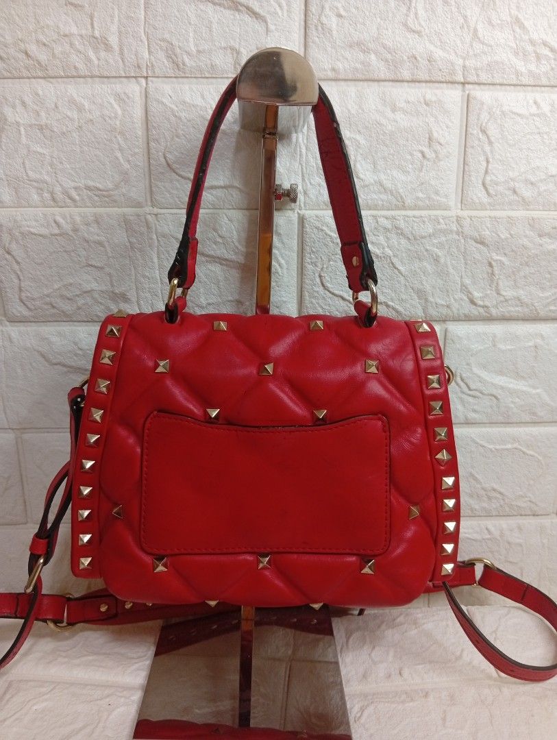Valentino Garavani Candystud Medium Top Handle Bag (Category: Luxury Bags & Wallets) located in Las Pinas. Submitted by etoksi1234 (Listing ID 1469559439, Image 2). Description: Pre-loved Valentino Garavani Candystud Medium Top Handle Bag in Rosso Valentino red, crafted from quilted lambskin leather with antique brass-finish hardware, pyramid studs, a top handle, and a detachable shoulder strap..
