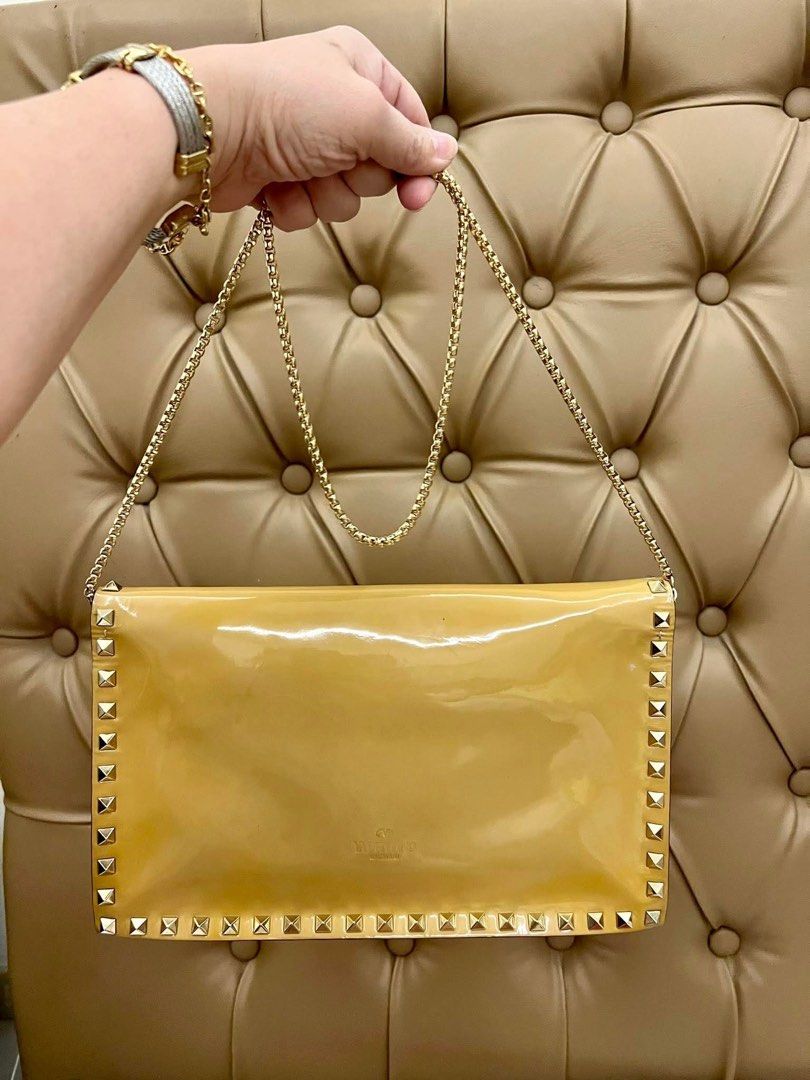 VALENTINO Rockstud Clutch Bag (Category: Luxury Bags & Wallets) located in Quezon City. Submitted by yassismom (Listing ID 1469456167, Image 2). Description: 8/10 condition, caramel color super classy and elegant can be worn as a shoulder bag with after market chain slight color transfer inside but not noticeable bought for almost 60K+ guranteed authentic or money back!💯.