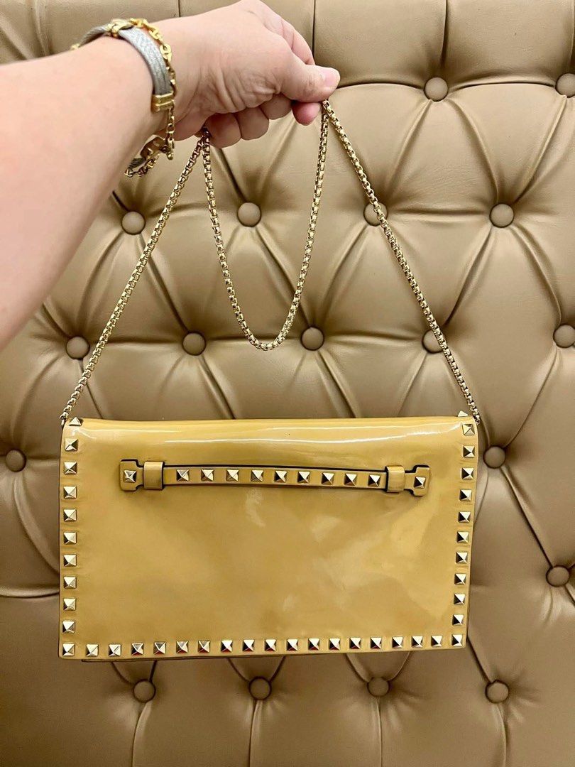 VALENTINO Rockstud Clutch Bag (Category: Luxury Bags & Wallets) located in Quezon City. Submitted by yassismom (Listing ID 1469456167, Image 3). Description: 8/10 condition, caramel color super classy and elegant can be worn as a shoulder bag with after market chain slight color transfer inside but not noticeable bought for almost 60K+ guranteed authentic or money back!💯.