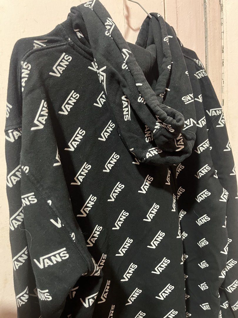 Vans All Over Print Black Hoodie (Category: Hoodies) located in Manila. Submitted by pinkmowchiiii (Listing ID 1469512333, Image 3). Description: - Color: Black with all-over white Vans text print - Style: Standard fit hooded sweatshirt - Storage: Front kangaroo pocket - Features: Adjustable drawstring hood, ribbed cuffs and hem - Material: Soft and comfortable cotton blend - Condition: Great for casual everyday wear.