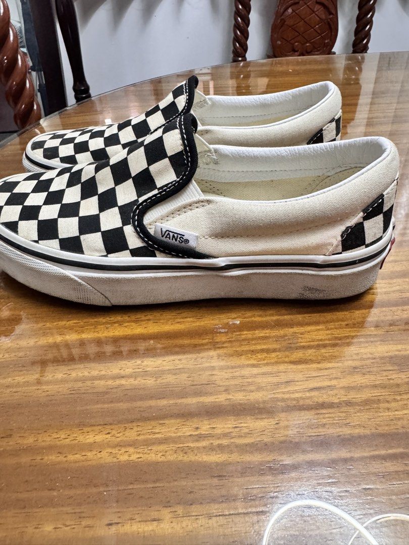 Vans Classic Checkerboard Slip-On Sneakers (Category: Sneakers) located in Batangas. Submitted by ayeeftz (Listing ID 1469424494, Image 2). Description: - Style: Classic slip-on with iconic black and white checkerboard pattern - Size: US Men 3.5 / US Women 5 / EUR 34.5 / 21.5 cm - Details: Features elastic side accents and red 'Off The Wall' heel license plate.