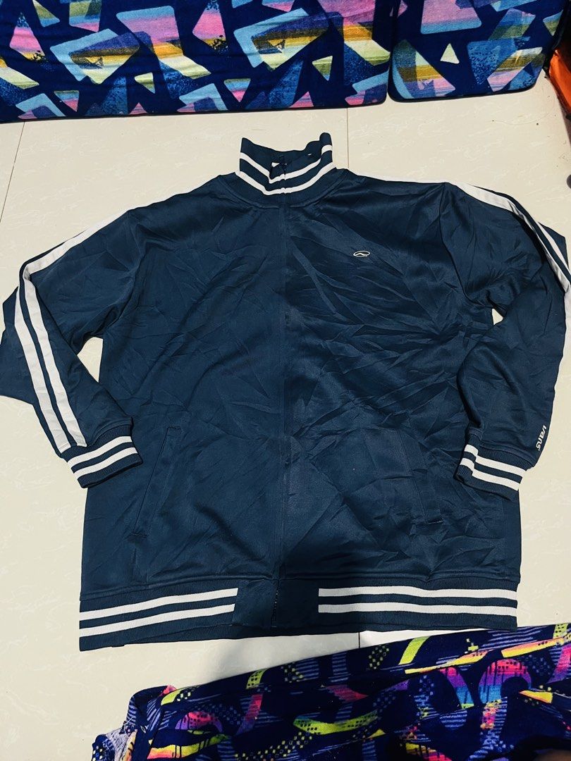 Vans Navy Blue Track Jacket Striped Collar Cuff XL (Category: Coats, Jackets and Outerwear) located in Manila. Submitted by athan0800 (Listing ID 1469472859, Image 1). Description: - Brand: Vans - Style: Navy blue track jacket with white stripes - Size: X-Large - Details: Full zip closure, side pockets, ribbed collar, cuffs, and hem - Branding: Embroidered Vans logo on chest and left cuff - Look: Classic sporty streetwear - Condition: Excellent.