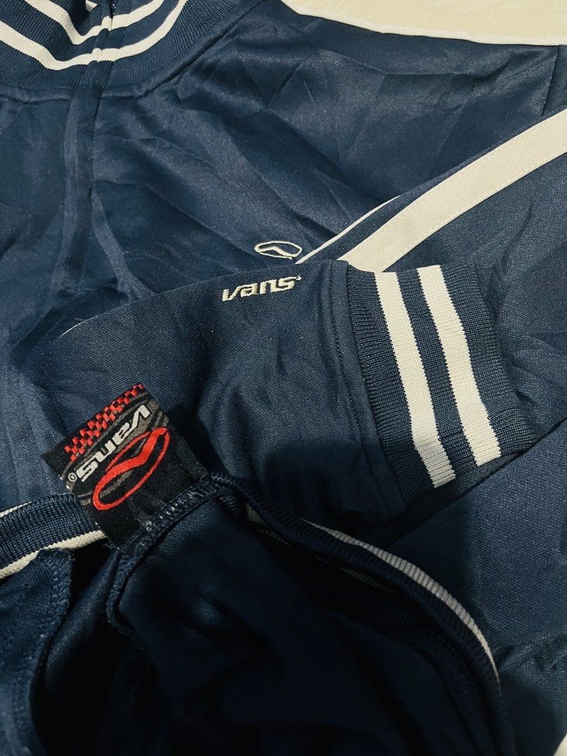 Vans Navy Blue Track Jacket Striped Collar Cuff XL (Category: Coats, Jackets and Outerwear) located in Manila. Submitted by athan0800 (Listing ID 1469472859, Image 3). Description: - Brand: Vans - Style: Navy blue track jacket with white stripes - Size: X-Large - Details: Full zip closure, side pockets, ribbed collar, cuffs, and hem - Branding: Embroidered Vans logo on chest and left cuff - Look: Classic sporty streetwear - Condition: Excellent.