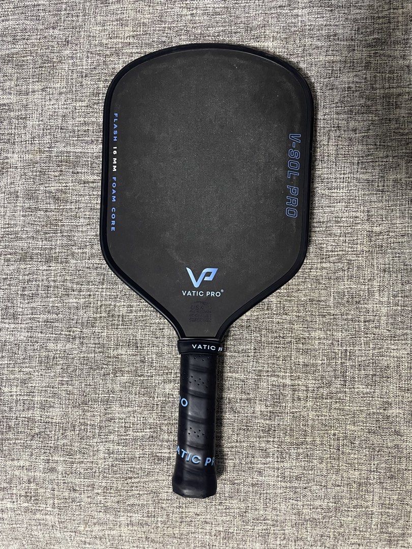 Vatic Pro V-Sol Pro Flash 16mm Pickleball Paddle (Category: Racket and Ball Sports) located in Cordon. Submitted by secondgreatt (Listing ID 1469406887, Image 3). Description: - Brand: Vatic Pro V-Sol Pro Flash - Thickness: 16mm foam core construction for power and control - Condition: Pristine, zero wear marks on the face or edge guard - Design: Sleek black surface with striking blue lettering and branding - Handle: Standard perforated grip wrap