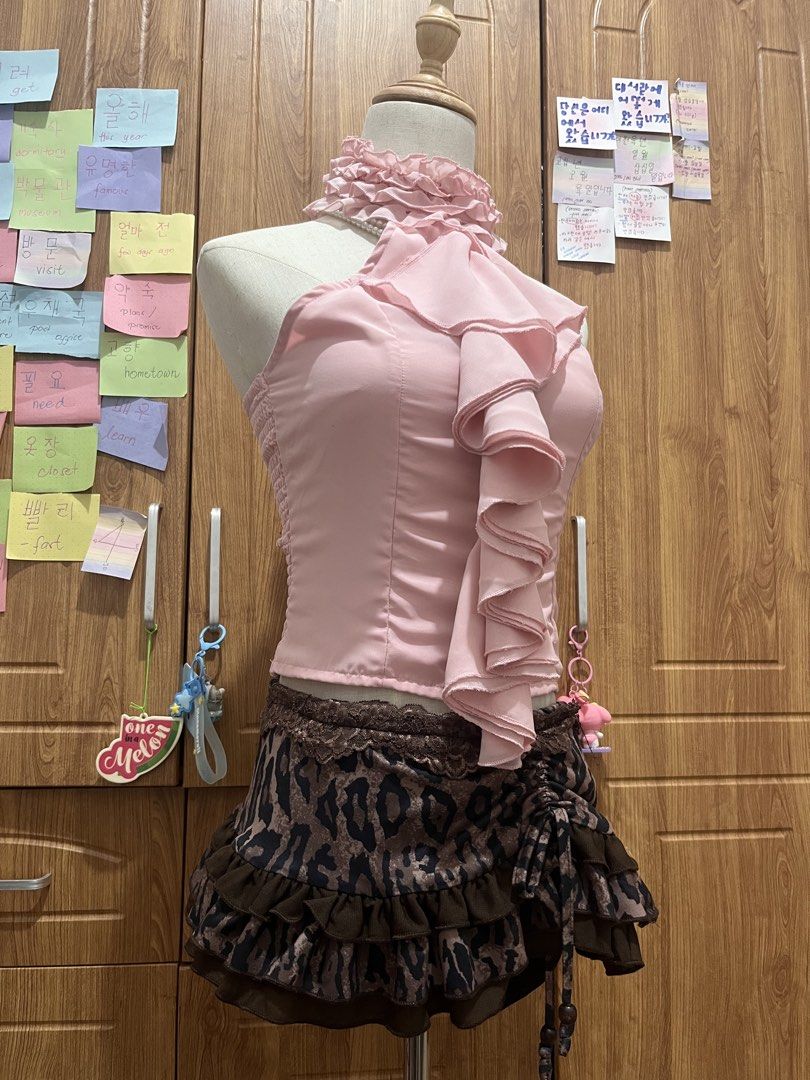 Vietnam Clothes sold as Set (Category: Sets or Coordinates) located in Manila. Submitted by brightwind_62659f (Listing ID 1469475291, Image 3). Description: - Y2K coord set: Camo halter top + brown plaid pleated mini skirt - Top details: Pink lace trim and front ribbon ties - Skirt details: Layered design with mixed plaid patterns - Size: Fits XS, S and M - Condition: Clean and ready to wear.