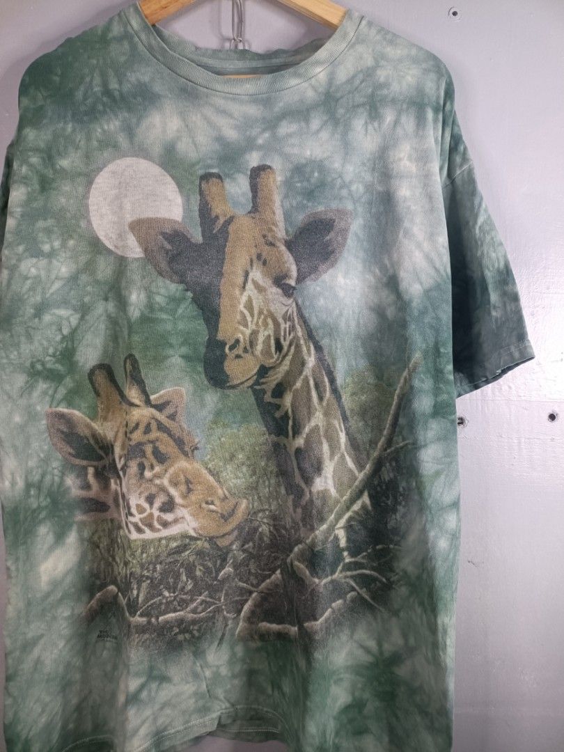 Vintage 1999 The Mountain Giraffe Tee (Category: Tshirts & Polo Shirts ) located in Cabuyao City. Submitted by junkthreads.finds (Listing ID 1469509583, Image 2). Description: Tag: Missing Dimes: 23x30 Issue(s): Minimal graphic fading Color may vary due to lightning..