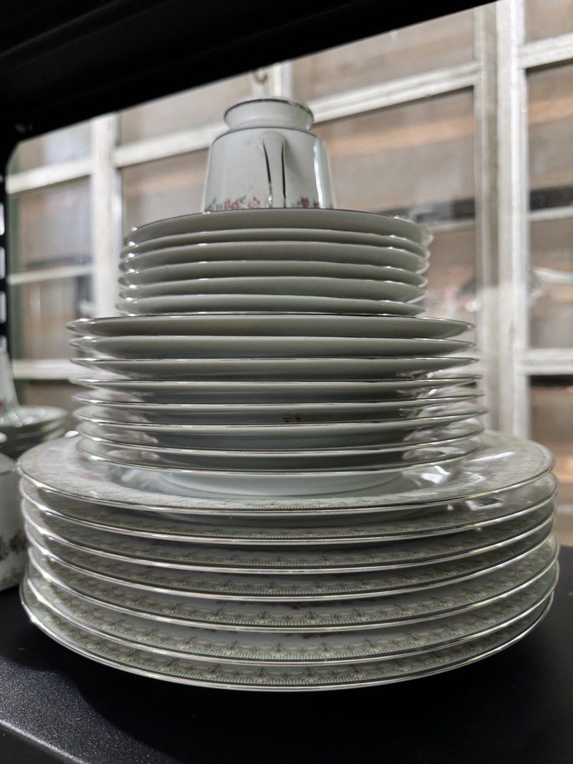 Vintage 80s Noritake Roselane Dinnerware Set (Category: Dinnerware & Cutlery) located in Quezon City. Submitted by luckypicker.25 (Listing ID 1469395642, Image 1). Description: Noritake Roselane Fine China (Pattern 3093) Origin: Made in the Philippines Design: White porcelain with pink roses, green leaves, delicate geometric borders, and silver trim. Set includes multiple stacked plates, cups, serving bowls and platters. Condition: Vintage, well 