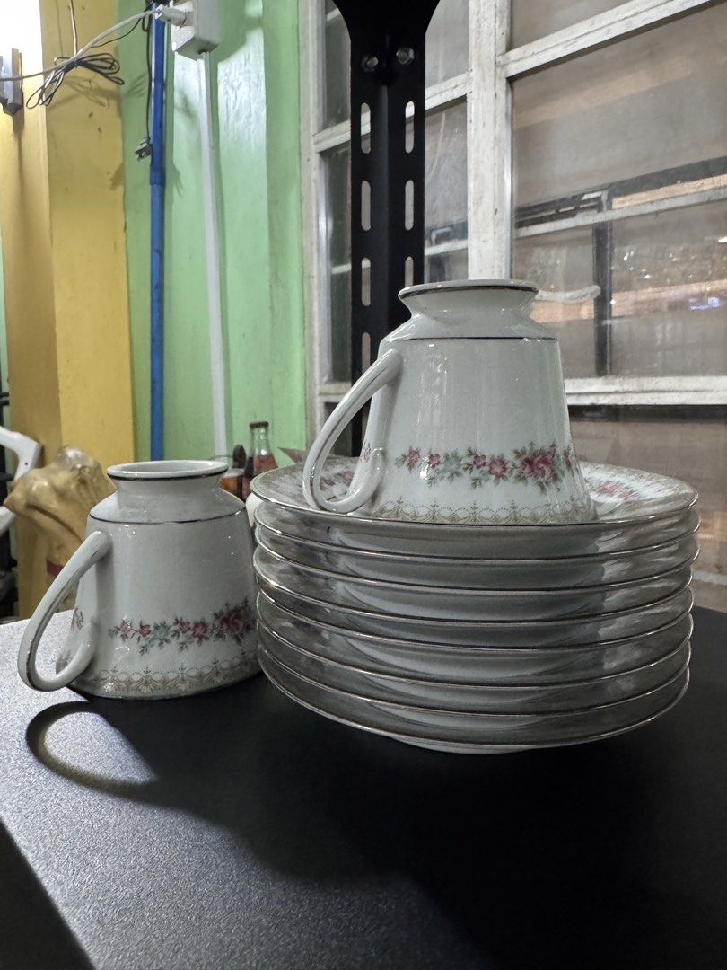 Vintage 80s Noritake Roselane Dinnerware Set (Category: Dinnerware & Cutlery) located in Quezon City. Submitted by luckypicker.25 (Listing ID 1469395642, Image 2). Description: Noritake Roselane Fine China (Pattern 3093) Origin: Made in the Philippines Design: White porcelain with pink roses, green leaves, delicate geometric borders, and silver trim. Set includes multiple stacked plates, cups, serving bowls and platters. Condition: Vintage, well 