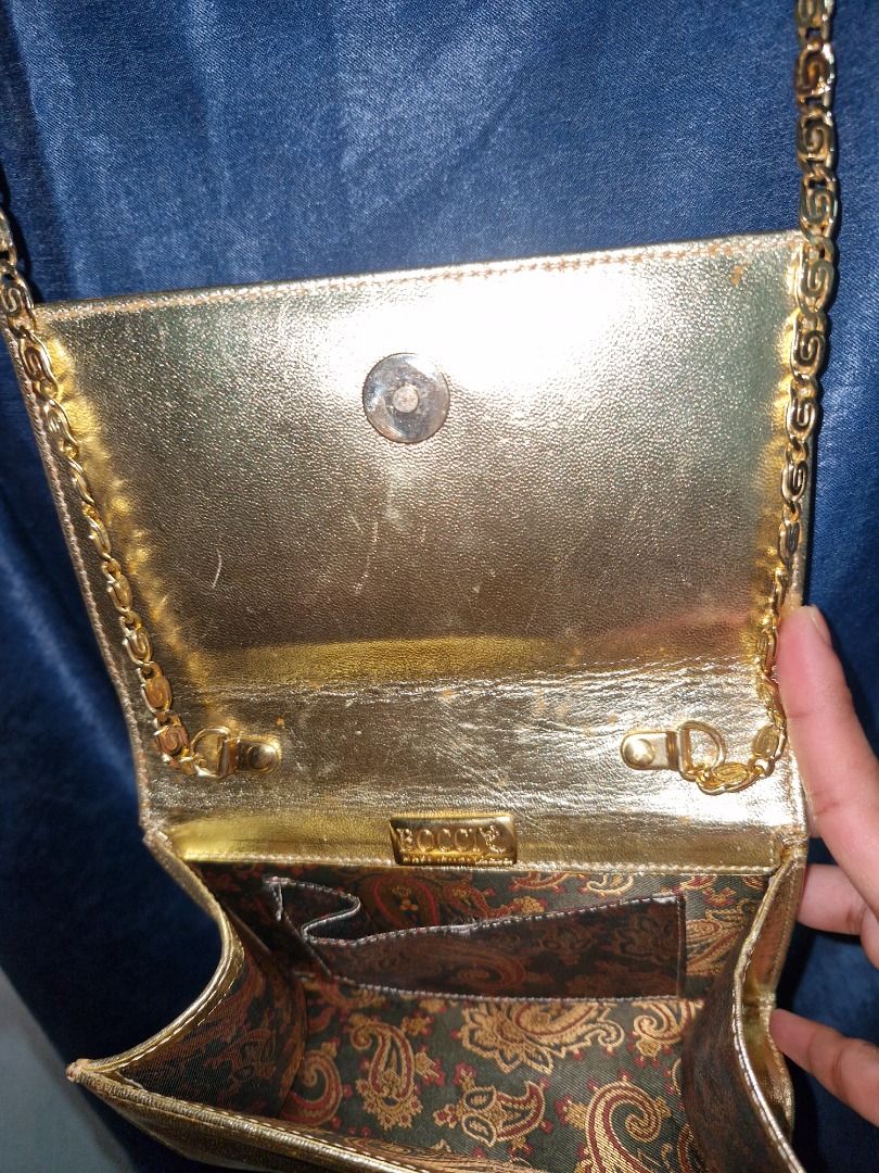 Vintage Bag (Category: Luxury Bags & Wallets) located in Cabuyao City. Submitted by titasolph (Listing ID 1469405103, Image 2). Description: Elegant gold evening bag — timeless piece! • Authentic BOCCI • Made in Italy • Detachable chain strap • Vintage charm & beautiful interior • Good condition for its age 💰 ₱2,500 only! 📍 Laguna 📩 DM to claim!.