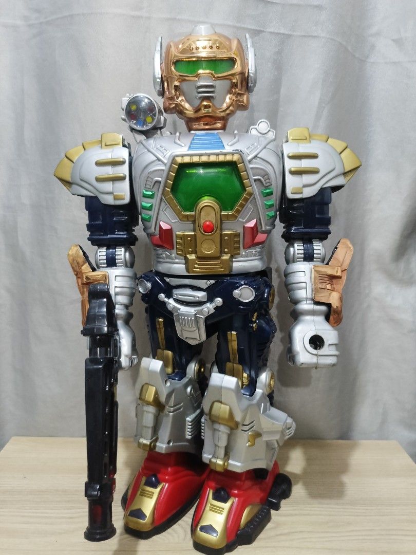 Vintage Battery Robot (Category: Action & Battle Toys) located in Cavite. Submitted by bodega_ni_kiks11 (Listing ID 1469415672, Image 1). Description: 17" Vintage Battery Robot – Lights & Sounds Working - Big 17-inch robot. Gold head, green chest panel, multi-color shoulder lights, black gun included. - Lights up and has sounds when switched on. -Does NOT walk. No shield. As-is condition. Not for picky buyers. Meet-up or shipping available. PM fo