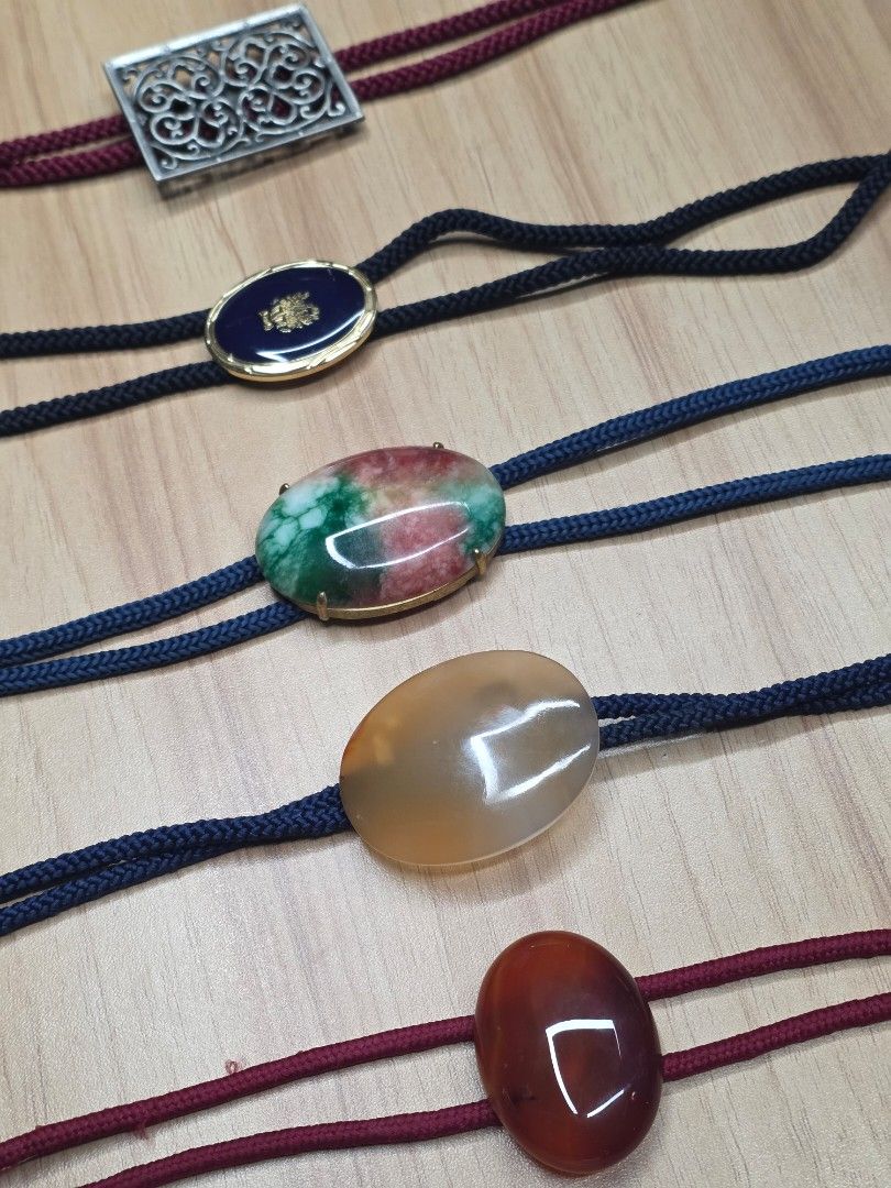 Vintage Bolo Tie Set Assorted Gemstone Western Necktie (Category: Ties) located in Quezon City. Submitted by gonzzzzz (Listing ID 1469520290, Image 2). Description: - Set of 5 unique bolo ties for western wear or statement looks - Centerpieces include reddish-brown stone, translucent agate, green/red mottled stone, blue enamel with crest, and silver-tone metal filigree - Features burgundy and dark blue braided cords with metal tips - Selling as a