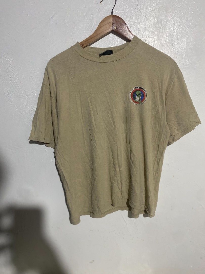 Vintage Bugle Boy Alien Graphic T-shirt Beige Medium (Category: Tshirts & Polo Shirts ) located in Maasin. Submitted by trippythirftyyy (Listing ID 1469481075, Image 1). Description: - Brand: Bugle Boy - Color: Tan - Size/Fit: Relaxed 90s streetwear fit - Design: Small alien logo on chest pocket, large 1997 copyrighted alien graphic on the back - Details: Short sleeves, crew neckline, vintage condition.