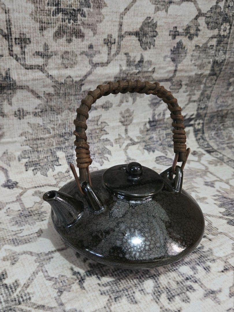 Vintage ceramic teapot (Category: Coffee & Tea Tableware) located in Manila. Submitted by cwknds (Listing ID 1469467732, Image 2). Description: timeless little piece with a dark crackle glaze, rustic woven handle, and a distinctive ufo-like shape. its rounded silhouette gives it a playful yet understated charm, perfect for collectors who appreciate pieces a little out of the ordinary. • 7 x 15 cm • potter's mark ~ personally sourced&curated.