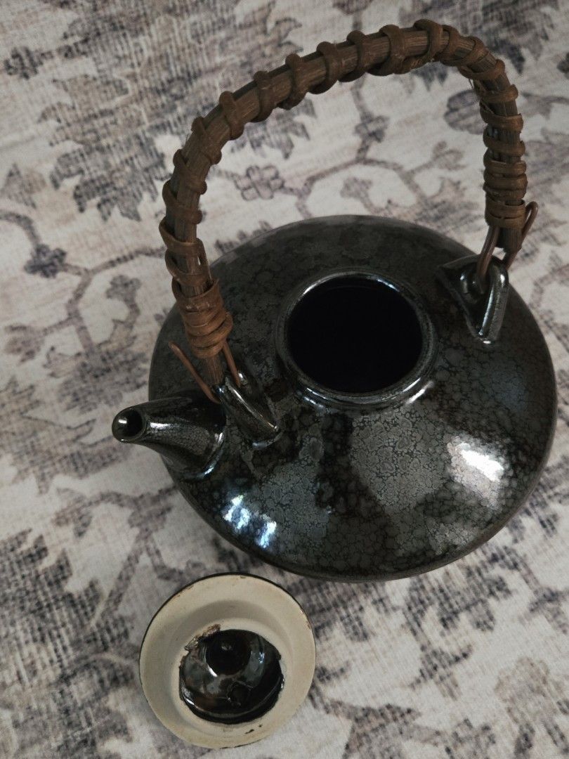 Vintage ceramic teapot (Category: Coffee & Tea Tableware) located in Manila. Submitted by cwknds (Listing ID 1469467732, Image 3). Description: timeless little piece with a dark crackle glaze, rustic woven handle, and a distinctive ufo-like shape. its rounded silhouette gives it a playful yet understated charm, perfect for collectors who appreciate pieces a little out of the ordinary. • 7 x 15 cm • potter's mark ~ personally sourced&curated.