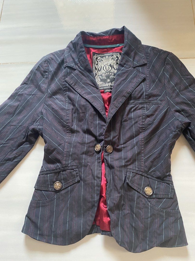 Vintage Guess Striped Stretch Blazer Jacket Size S (Category: Coats, Jackets and Outerwear) located in Santa Rosa. Submitted by honeyrackk (Listing ID 1469443074, Image 1). Description: - Brand: Guess - Color: Dark grey with vertical pinstripes - Size: S (Stretch fabric construction) - Closure: Two-button front with ornate metal buttons - Pockets: Lower flap pockets and a small chest pocket - Interior: Vibrant red satin lining with blue piping tr