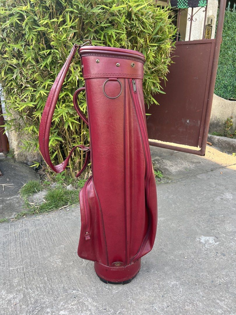 Vintage Maroon Leather Golf Bag (Category: Golf) located in Manila. Submitted by livefish.26c802 (Listing ID 1469527937, Image 1). Description: - Color & Material: Maroon synthetic leather with metal hardware accents - Design: Structured vintage cylindrical shape - Storage: Zippered side pockets and secure top club divider - Comfort: Durable carrying strap for easy transport - Condition: Clean interior lining.