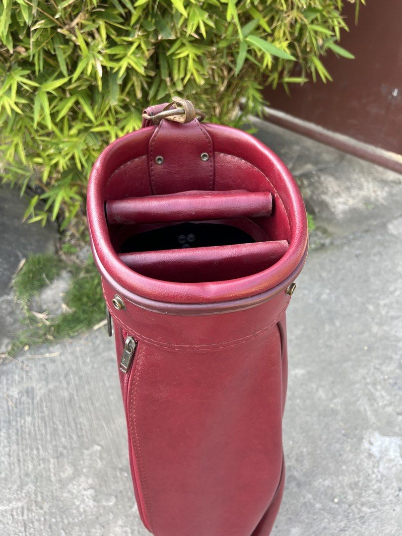 Vintage Maroon Leather Golf Bag (Category: Golf) located in Manila. Submitted by livefish.26c802 (Listing ID 1469527937, Image 3). Description: - Color & Material: Maroon synthetic leather with metal hardware accents - Design: Structured vintage cylindrical shape - Storage: Zippered side pockets and secure top club divider - Comfort: Durable carrying strap for easy transport - Condition: Clean interior lining.