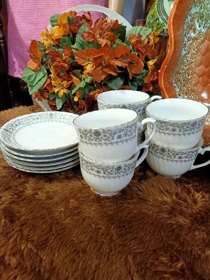 Vintage Porcelain Teacup and Saucer Set Grey Scroll Pattern (Category: Coffee & Tea Tableware) located in Manila. Submitted by shawn0320_fish (Listing ID 1469464847, Image 2). Description: - White porcelain matching teacups and saucers set - Features detailed grey scroll and floral filigree pattern - Scalloped edges accented with silver trim - Ribbed cup bodies with classic footed bases - Multiple matching pieces included - Clean surfaces with no