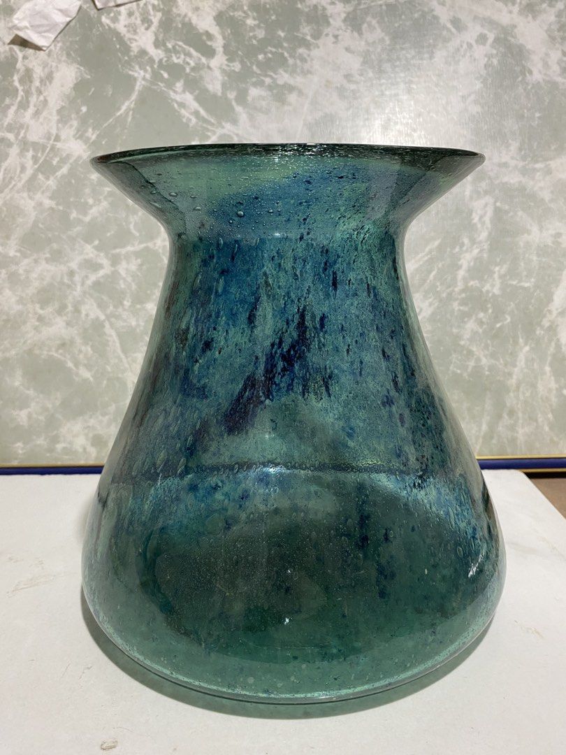 Vintage Recycled Glass Vase (Category: Vases & Decorative Bowls) located in Calamba. Submitted by chebvintagedepot (Listing ID 1469475875, Image 1). Description: (TBOX4-02) Decorative glass vase featuring a mottled teal and sea-green finish with a speckled appearance. It has a bulbous body and a wide, flared rim, giving it a distinctive shape. The vase has the look of hand-blown recycled glass and would make a nice display piece on a shelf, sideb