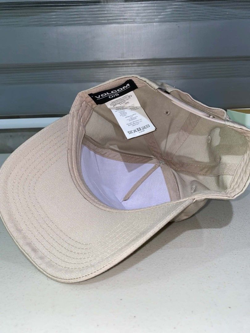 Volcom Stone Company Snapback Cap Beige (Category: Caps & Hats) located in Baler. Submitted by mariokush193815 (Listing ID 1469453415, Image 3). Description: - Brand: Volcom Stone Company - Color: Classic Beige - Condition: Brand new with sticker still attached on the brim - Design: Structured crown with a curved brim - Details: Embroidered Volcom logo patch on the front - Closure: Adjustable plastic snapback with small logo tag - Fit: One Size F