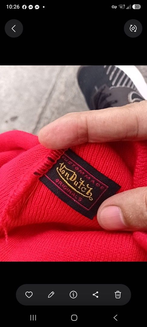 Von Dutch Red Knit Beanie (Category: Beanies) located in Manila. Submitted by grandflower-547aee (Listing ID 1469496991, Image 2). Description: - Brand: Von Dutch - Color: Bright red with large white branding - Material: Warm knit, features inner 'Kustommade Originals' tag - Style: Classic streetwear - Condition: Excellent - Perfect for: Cold weather and casual OOTDs.