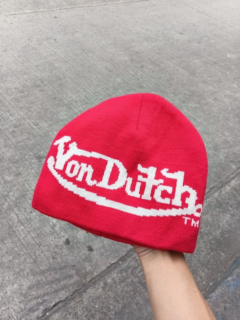 Von Dutch Red Knit Beanie (Category: Beanies) located in Manila. Submitted by grandflower-547aee (Listing ID 1469496991, Image 1). Description: - Brand: Von Dutch - Color: Bright red with large white branding - Material: Warm knit, features inner 'Kustommade Originals' tag - Style: Classic streetwear - Condition: Excellent - Perfect for: Cold weather and casual OOTDs.