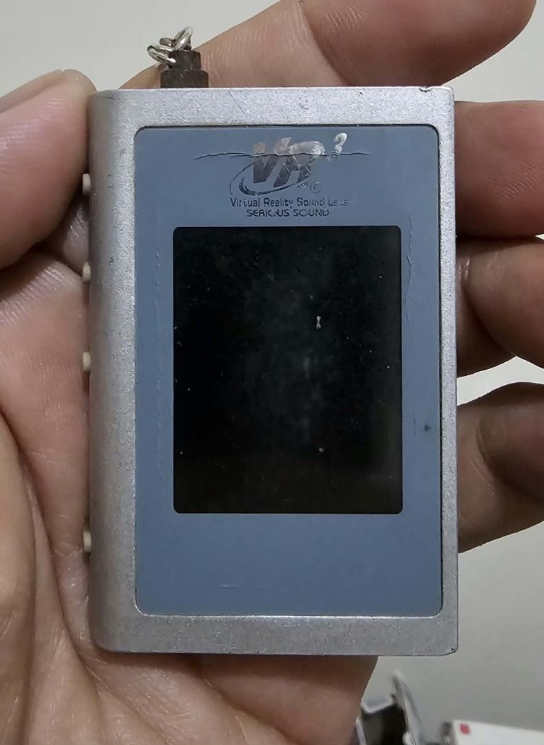 VR3 Virtual Reality Sound Lab MP3 Player (Category: Portable Music Players) located in Manila. Submitted by mwnadala (Listing ID 1469449536, Image 3). Description: Color: Silver Brand: Virtual Reality Sound Labs (VR3) Model: VKC190 Design: Silver-colored housing with a small LCD screen, side control buttons, a keychain loop at the top, and a mini-USB port on the side. Condition: Used Reason for Selling: No more need Meet Up Location: LRT 2 V Mapa