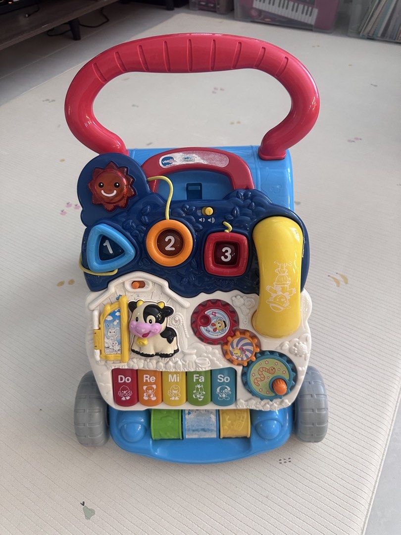 Vtech walker (Category: Infant Playtime) located in Singapore. Submitted by char.k (Listing ID 1469456625, Image 1). Description: Vtech baby walker. Sound and light in working condition just that my baby likes to pull off the sticker. The top and bottom (middle sticker) are peeled off.