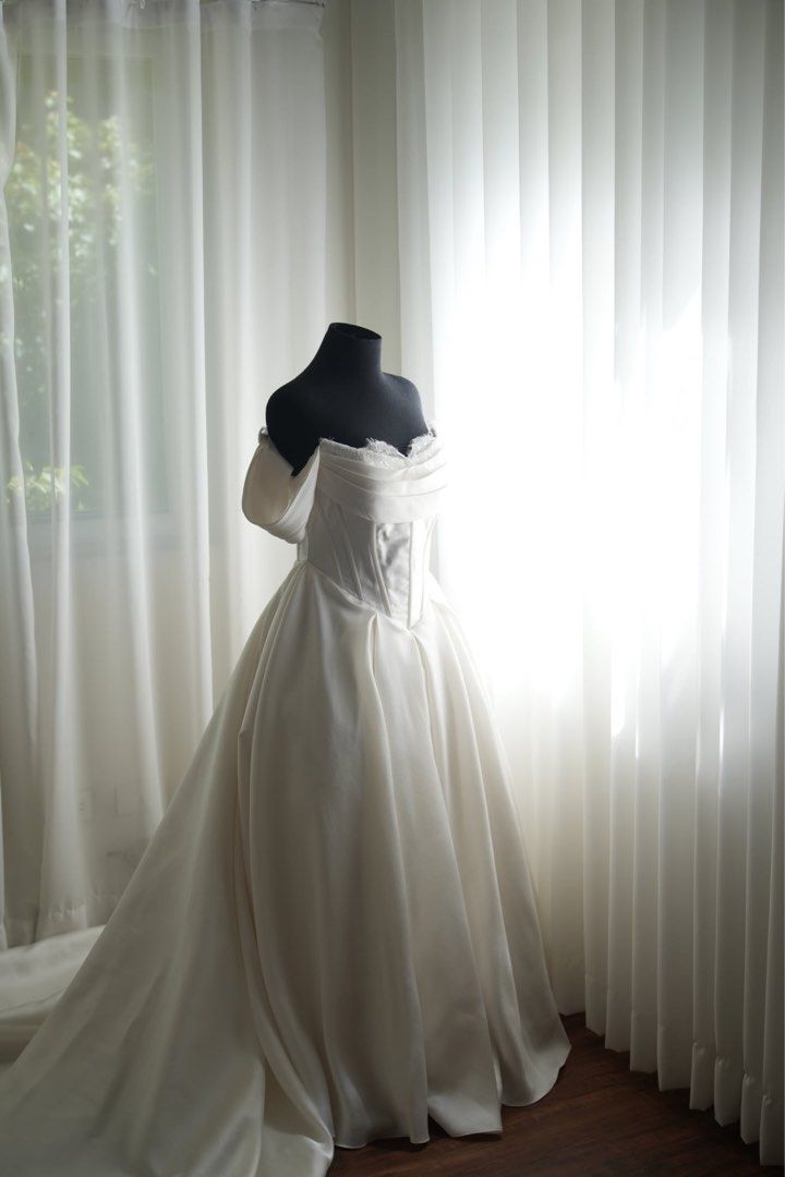 Wedding Gown (A-Line Corsette) (Category: Evening dresses & gowns) located in Pasig City. Submitted by iamthedanger (Listing ID 1469530479, Image 3). Description: - Brand: Zeta Bridal (Customized) - Style: A-Line Corset Wedding Gown with Train - Size: Small to Medium (m - Color: Classic Ivory / White - Features: Structured boned corset, with delicate lace trim, flowing full skirt, and versatile detachable sleeves - Detachable petty coat - Trail c