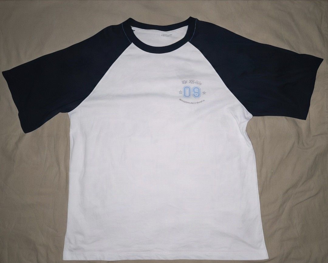 White and Navy Blue Raglan T-Shirt Class Graphic (Category: Shirts) located in Manila. Submitted by astro_mad05 (Listing ID 1469560340, Image 3). Description: - Color: White body with dark navy blue raglan sleeves - Design: Small light blue '09' print on front, large orange cartoon character graphic with 'The Best S3A in the world Champion' text on back - Material: Comfortable cotton - Style: Crew neck, streetwear vibe - Condition: Like New (read