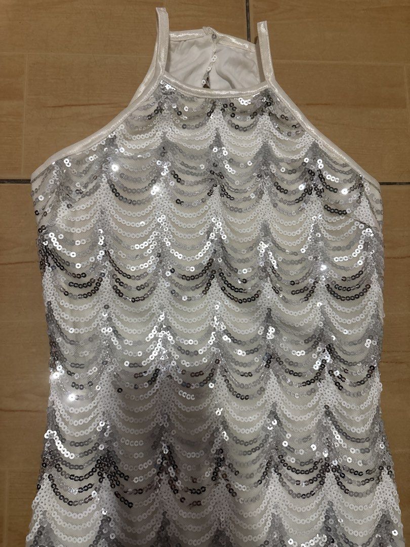 White and Silver Sequin Halter Party Dress (Category: Dresses) located in Cabuyao City. Submitted by airpz (Listing ID 1469441619, Image 2). Description: - Style: White halter neck dress with silver sequin scallop patterns - Fit: Sleeveless, fitted silhouette, knee-length - Details: Back neck zip closure - Condition: Worn just once, zero missing sequins, clean and ready to wear - Perfect for: Parties, celebrations, and nights out waist 26-27.