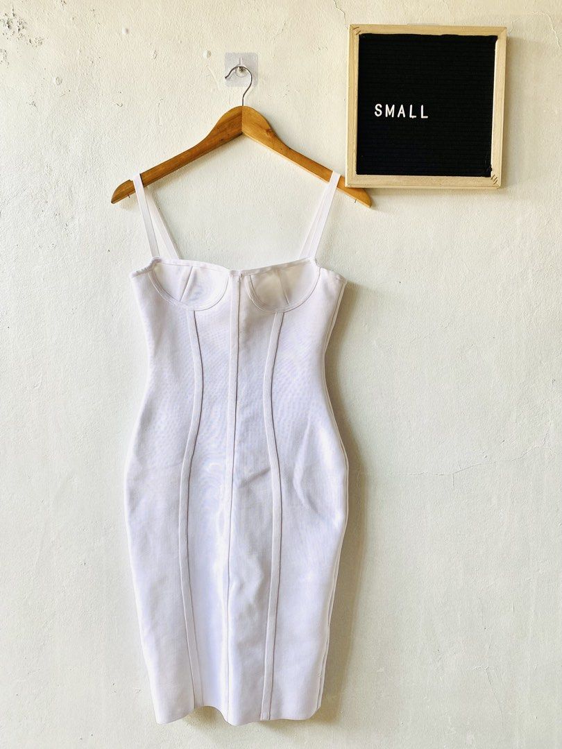 White Corset Bodycon Maxi Dress (Category: Dresses) located in Caloocan City. Submitted by lovemyclothes21 (Listing ID 1469464279, Image 1). Description: - Color: Clean, crisp white - Style: Bodycon midi dress with a fitted, curve-hugging silhouette - Details: Structured corset seaming, underwire cups, and thin spaghetti straps - Closure: Convenient back zipper - Size: Small (based on hanger tag).