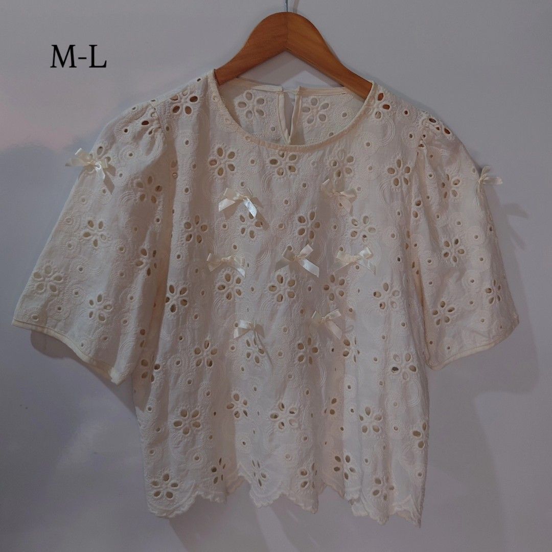White Eyelet Embroidered Bow Short Sleeve Blouse (Category: Blouses) located in Diffun. Submitted by declutteredbyJill (Listing ID 1469570633, Image 1). Description: - Color: White - Size: M-L - Design: Eyelet embroidery with scattered ribbon bows - Neckline: Round neck with back closure - Hem: Scalloped hemline - Fit: Relaxed fit, ideal for warm weather and casual outings.