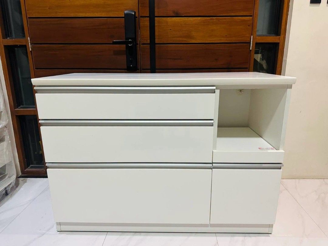 White Kitchen Counter Buffet Sideboard Cabinet Coffee Nook (Category: Shelves, Cabinets & Racks) located in Quezon City. Submitted by dannikkishoppe2 (Listing ID 1469569672, Image 2). Description: White Kitchen Counter Buffet Sideboard Cabinet Coffee Nook‼️₱8000‼️ *duco finish *soft-close drawers +built-in power outlet for microwave, rice cooker, or other appliances *good as new W47in x D20in x H33.5in Please manage your expectations as there mig