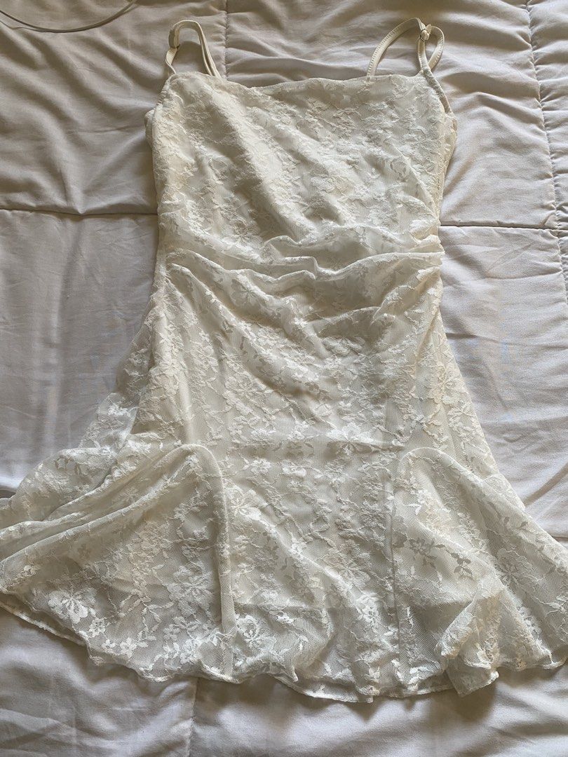 White Lace Mini Slip Dress with Adjustable Straps (Category: Dresses) located in Santa Rosa. Submitted by goosebag3l (Listing ID 1469471657, Image 1). Description: - Color: White - Pattern: Delicate floral lace throughout - Neckline: Scoop neck with adjustable metal hardware spaghetti straps - Fit: Fitted bodice with a flared ruffled hem - Lining: Fully lined interior - Fabric: Lightweight and easy to slip on - Condition: Brand new / Excellent.