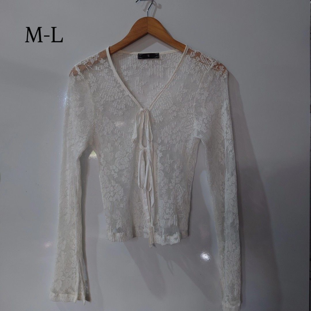 White Lace Tie Front Long Sleeve Cardigan (Category: Coats, Jackets and Outerwear) located in Diffun. Submitted by declutteredbyJill (Listing ID 1469570867, Image 1). Description: - Color & Material: White sheer lightweight mesh with floral pattern - Design: V-neckline, long sleeves, and double tie-front closure - Fit: Tagged as size S, but fits M to L comfortably - Styling: Perfect layering piece over camisoles and dresses - Condition: Excellent