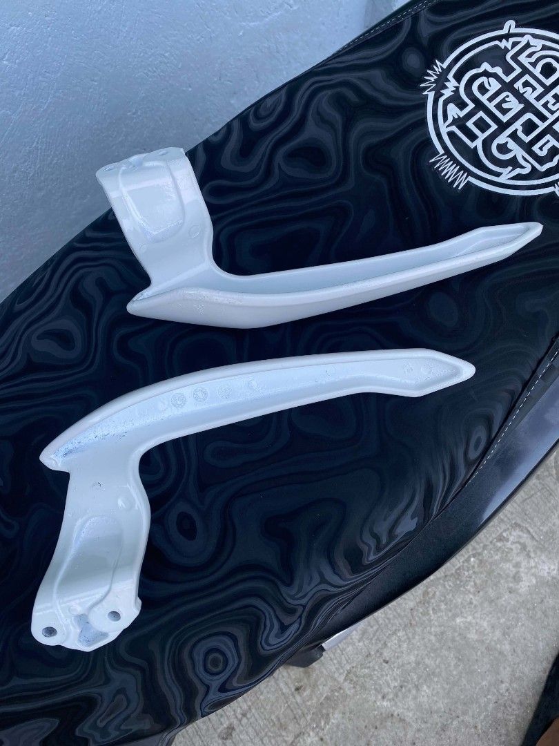 White scooter grab bar handles pair (Category: Other Motorcycles Parts and Accessories) located in Manila. Submitted by wilsonmani96639 (Listing ID 1469572258, Image 3). Description: - Item: Pair of motorcycle grab bar handles - Finish: Gloss white - Material: Solid metal construction - Condition: Clean, minimal signs of handling - Features: Pre-drilled mounting holes, ready to install on scooter tail section.