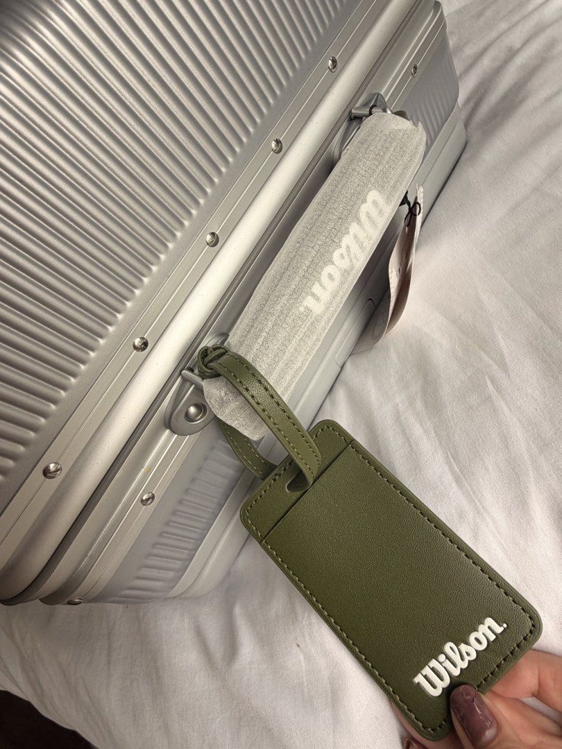 Wilson Silver Hardside Suitcase Luggage (Category: Luggage) located in Quezon City. Submitted by PrelovedbyPolene (Listing ID 1469409418, Image 3). Description: - Brand: Wilson Limited Edition - Color: Silver with vertical ribbed texture - Wheels: Smooth spinner wheels for easy mobility - Security: TSA-approved combination lock and secure metal clasps - Durability: Sturdy hardside frame with extra corner guards - Extras: Handle wrapped in protect