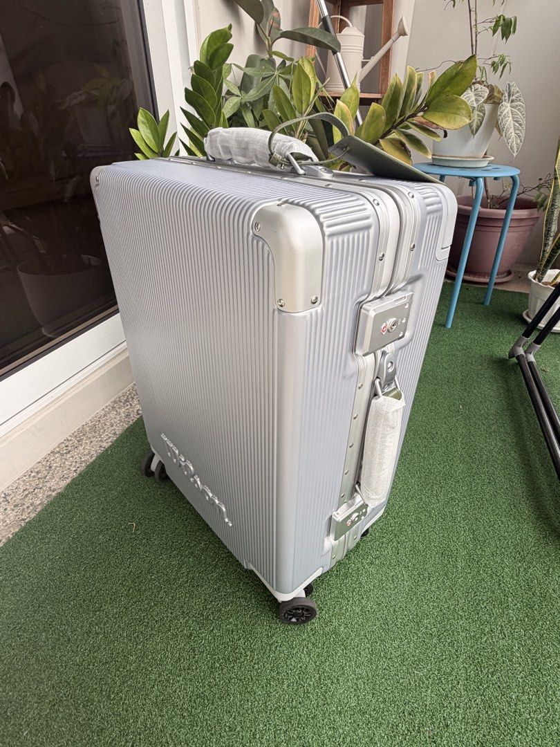 Wilson Silver Hardside Suitcase Luggage (Category: Luggage) located in Quezon City. Submitted by PrelovedbyPolene (Listing ID 1469409418, Image 1). Description: - Brand: Wilson Limited Edition - Color: Silver with vertical ribbed texture - Wheels: Smooth spinner wheels for easy mobility - Security: TSA-approved combination lock and secure metal clasps - Durability: Sturdy hardside frame with extra corner guards - Extras: Handle wrapped in protect