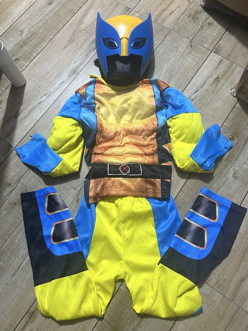 Wolverine Kids Costume with Mask (Category: Babies & Kids Fashion) located in Paranaque City. Submitted by zac.sei (Listing ID 1469395084, Image 1). Description: - Kids Wolverine costume - Includes full jumpsuit with printed muscle padding - Matching blue and yellow plastic mask with eye holes - Vibrant blue and yellow design - Perfect for Halloween, dress-up parties, and cosplay - Clean fabric, ready to wear.