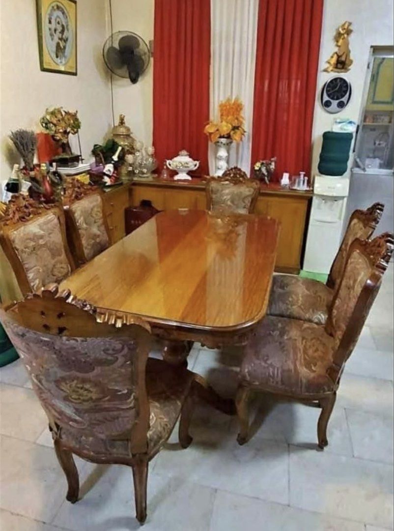 Narra Dining Table with Six Upholstered Chairs (Category: Tables & Sets) located in Quezon City. Submitted by chi__028 (Listing ID 1469424851, Image 1). Description: - Solid wooden dining table with an elegant glossy finish - Includes 6 matching chairs with comfortable patterned fabric upholstery - Features beautiful ornate carved details on table legs and chair backs - Extremely sturdy and durable build - Matching sideboard cabinet included in t