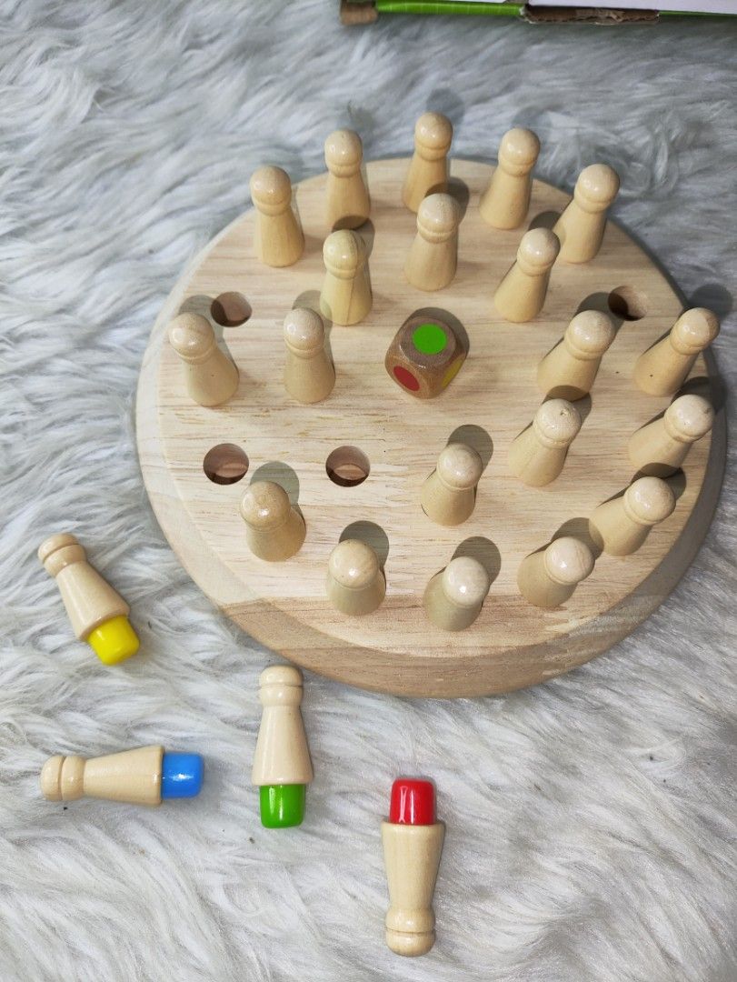 Wooden Memory Chess Color Matching Board Game (Category: Board Games & Puzzles) located in Cavite. Submitted by tinetaclesss (Listing ID 1469498239, Image 2). Description: - Fun wooden memory chess game designed for kids - Helps develop logical thinking, memory, and cognitive skills - Complete set: includes round wooden board, colorful pegs, and dice - Comes with the original box.
