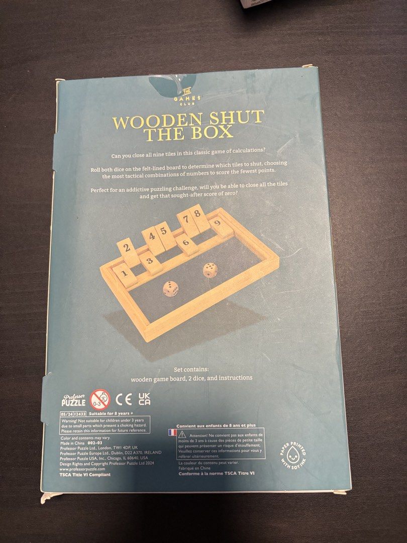 Wooden Shut The Box Board Game (Category: Board Games & Puzzles) located in Manila. Submitted by mganovelo64040 (Listing ID 1469479338, Image 2). Description: - Classic calculation game from The Games Club - Includes wooden board with numbered tiles (1-9), two wooden dice, and instructions - Quiet felt-lined playing surface to minimize noise - Great strategy challenge for 1 player, ages 8 and up - Original box included.