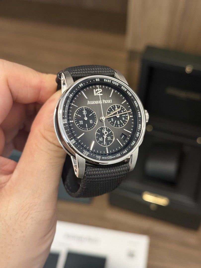 WTS LNIB Audemars Piguet AP Code 11.59 Chronograph 26393NB.OO.A002KB.01 White Gold Ceramic Smoked Grey Full Set (Category: Watches) located in Singapore. Submitted by dennisrodman1969 (Listing ID 1469551440, Image 2). Description: - Brand: Audemars Piguet Code 11.59 Chronograph Flyback - Dial: Black textured with Arabic numeral 12 and sub-dials - Movement: Swiss-made self-winding - Straps: Black textured strap + two extra m straps included - Acce