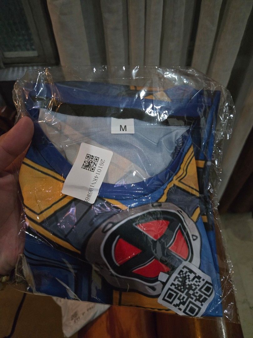 X-Men Cyclops Drifit Shit (Category: Activewear) located in Marikina City. Submitted by parcelpal.store (Listing ID 1469495504, Image 2). Description: - Brand new, unopened in original plastic packaging with barcode and QR code stickers - Iconic X-Men superhero costume design in a striking blue and yellow colorway - Features the classic X-Men logo on the chest and printed utility belt details - Size M tag attached on the collar - Perfect for Marv